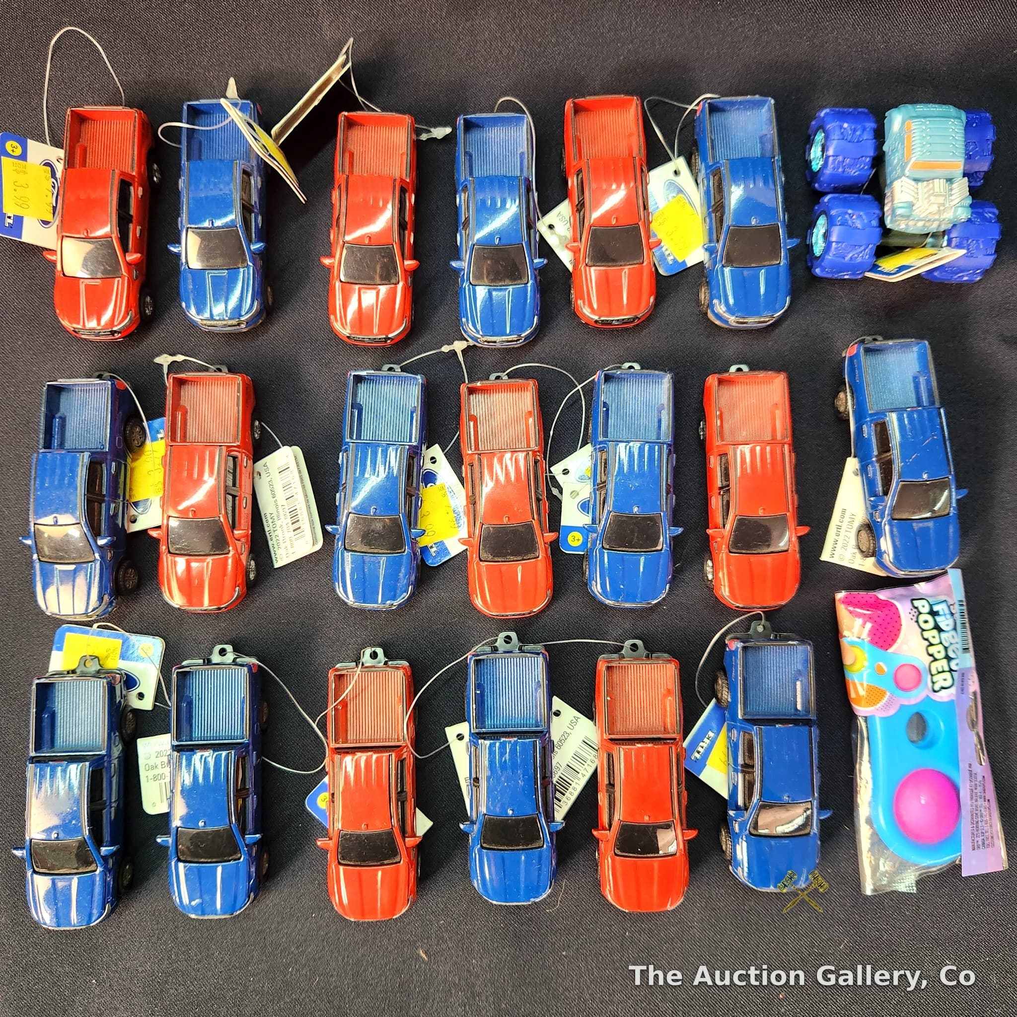 Lot of 21 Toy Vehicles โ ERTL Ford Ranger Trucks, Monster Truck & Fidget Popper